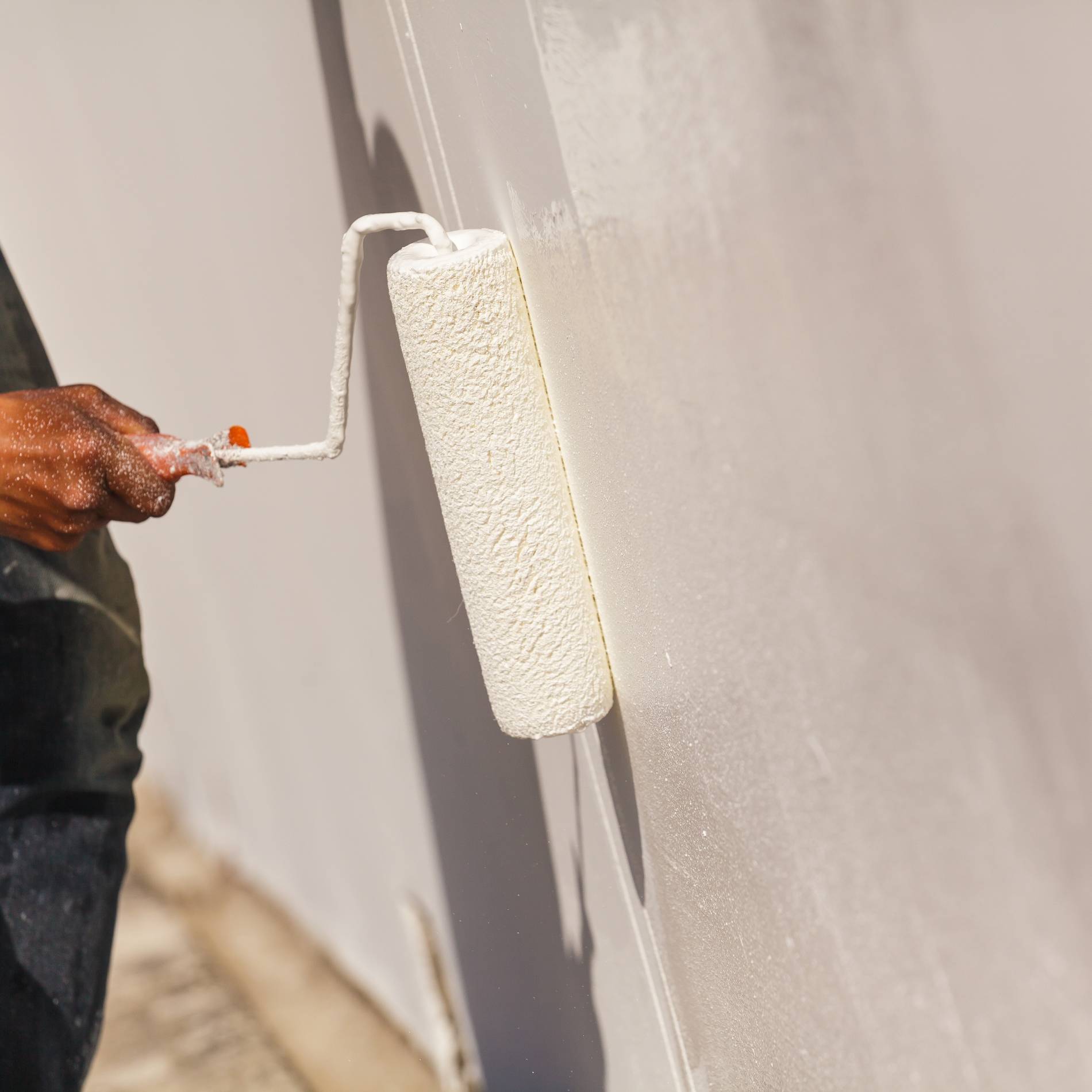 Painter man at work with a paint roller